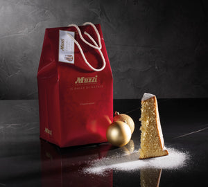 Italian Christmas pandoro cake with powdered sugar packet by Muzzi