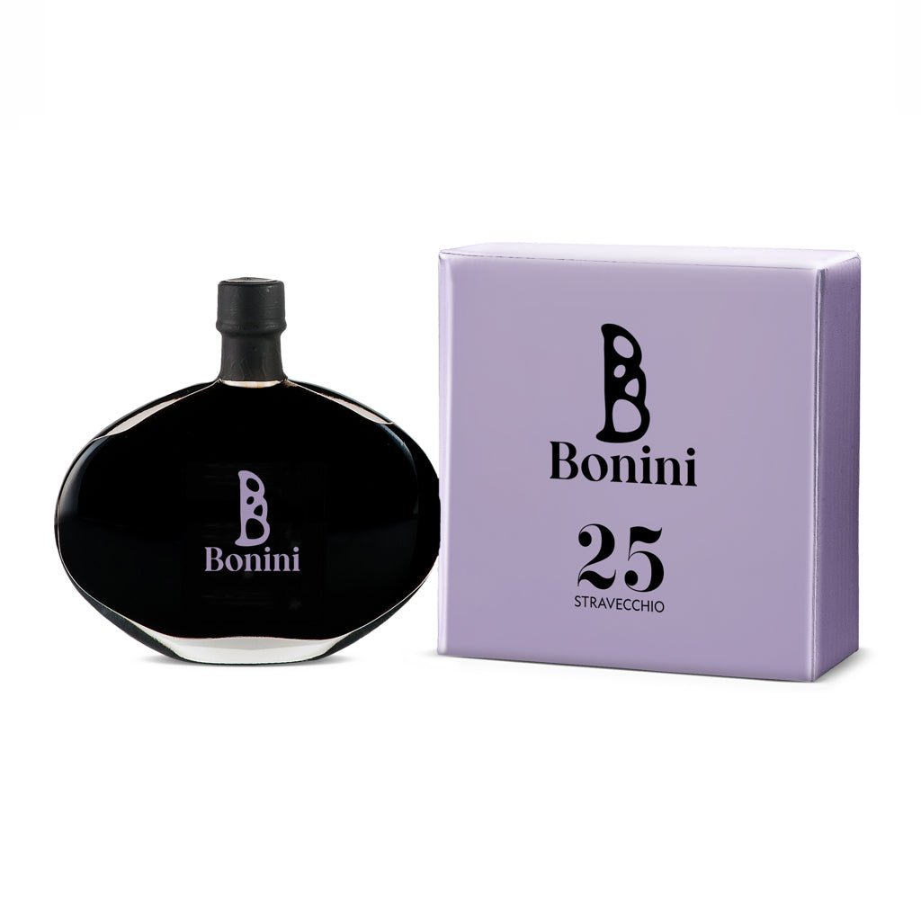 A bottle of Bonini Stravecchio 25-Year Aged Balsamic Vinegar next to its purple packaging box.
