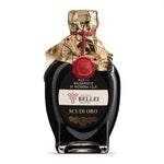 Bottle of Acetaia Bellei Modena I.G.P. balsamic vinegar with gold wrapper on a white background