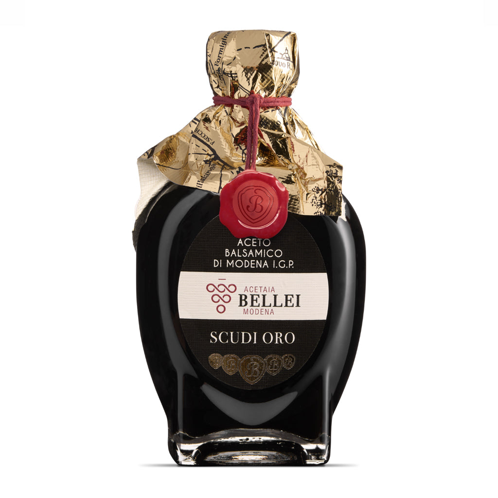 Bottle of Acetaia Bellei Modena I.G.P. balsamic vinegar with gold wrapper on a white background