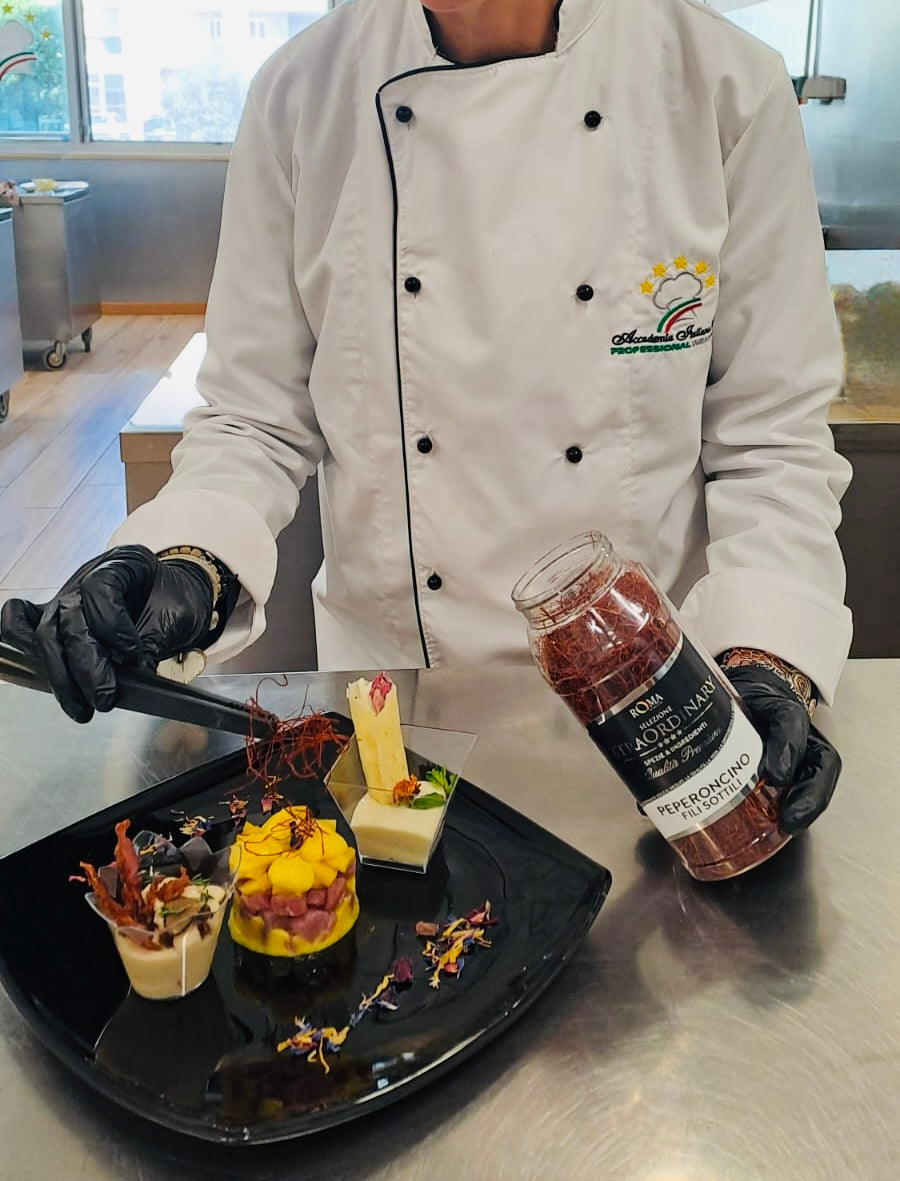 Chef preparing desserts with thin chili threads