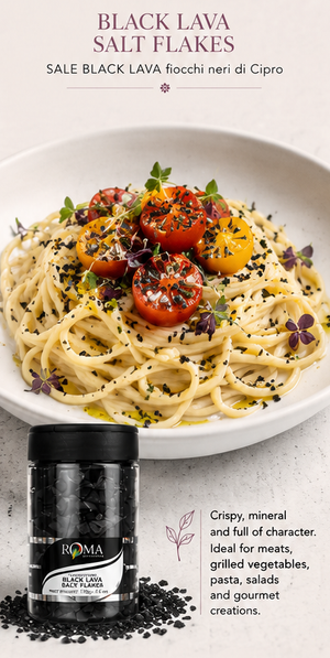 pasta plated with tomatos and black lava salt flakes