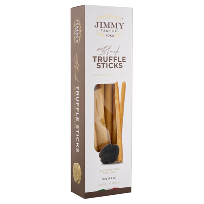 Jimmy Tartufi Truffle Sticks in a tall white and brown cardboard box with a clear window showing the sticks inside, photographed on a light gray background.