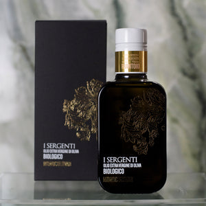 I Sergenti organic extra virgin olive oil monocultivar bottle on glass surface with marble background - Tita Italia Shop 