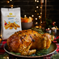 christmas table with a roasted chicken on a green plate some rosemary on it and I bibanesi pack on the side abs some breadsticks on the table. Christmas background 