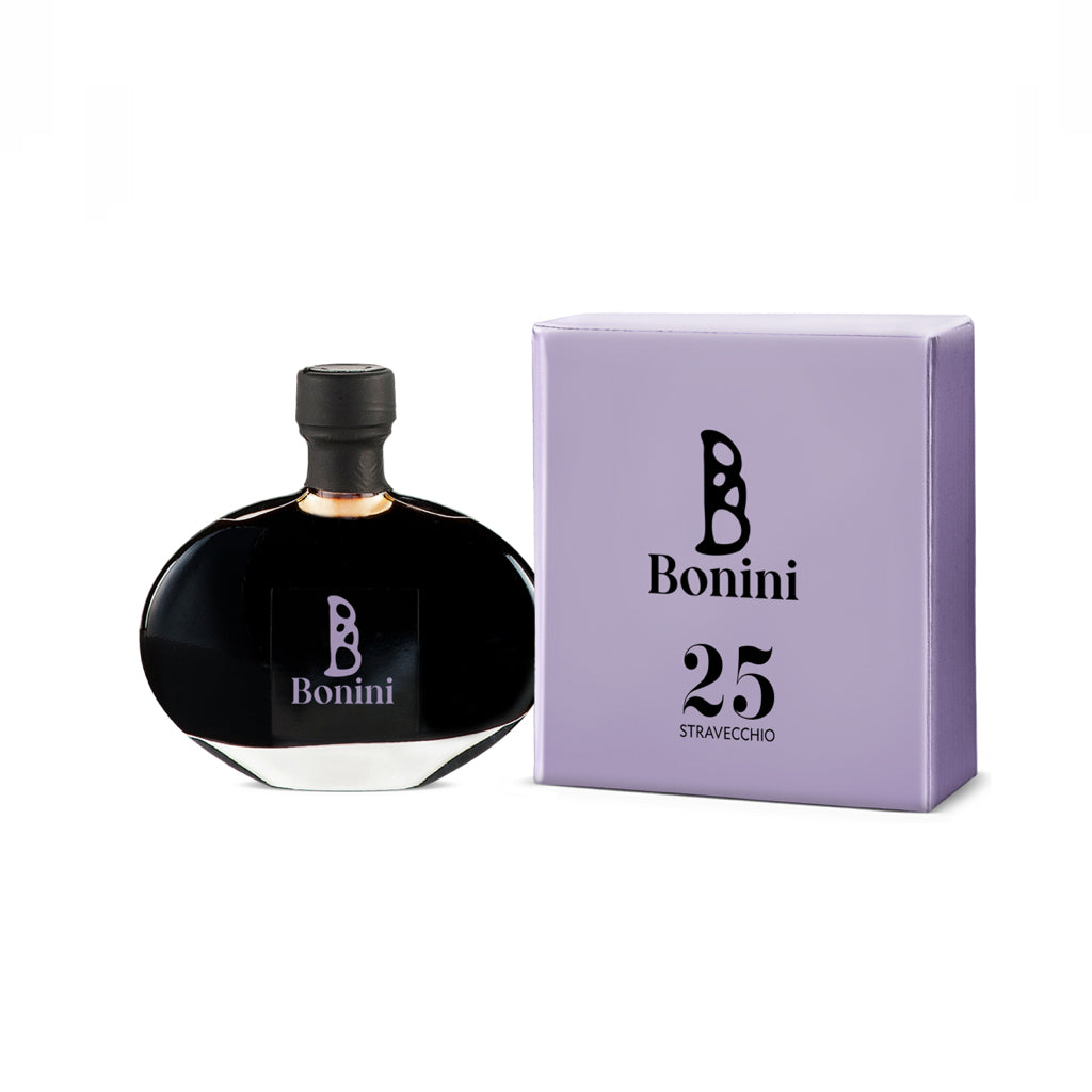 A bottle of Bonini Stravecchio 25-Year Aged Balsamic Vinegar next to its purple packaging box.