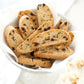 cantucci with almonds in a white bowl on a white table
