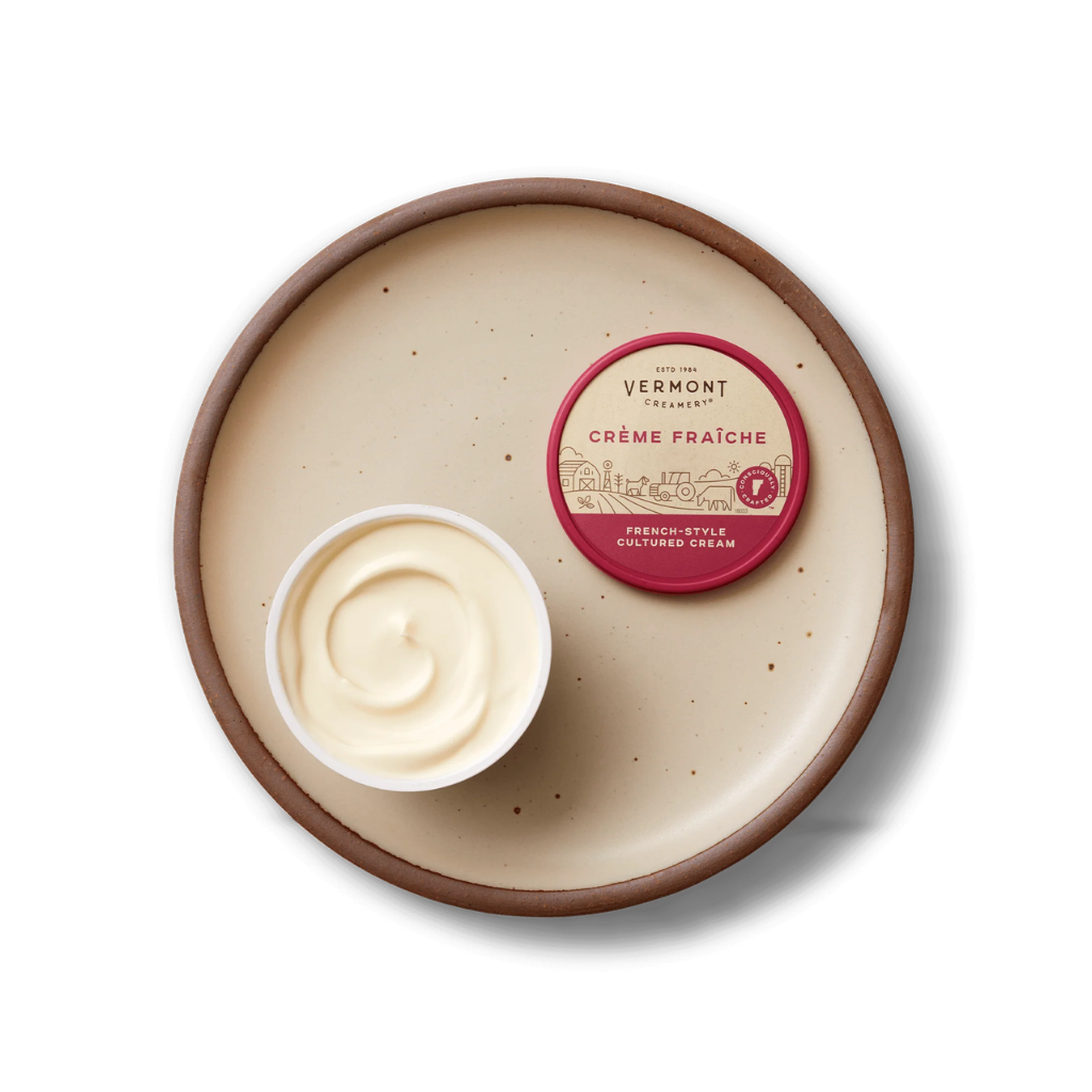 Bowl of Vermont Creamery Crème Fraçèère with a small container on a white background
