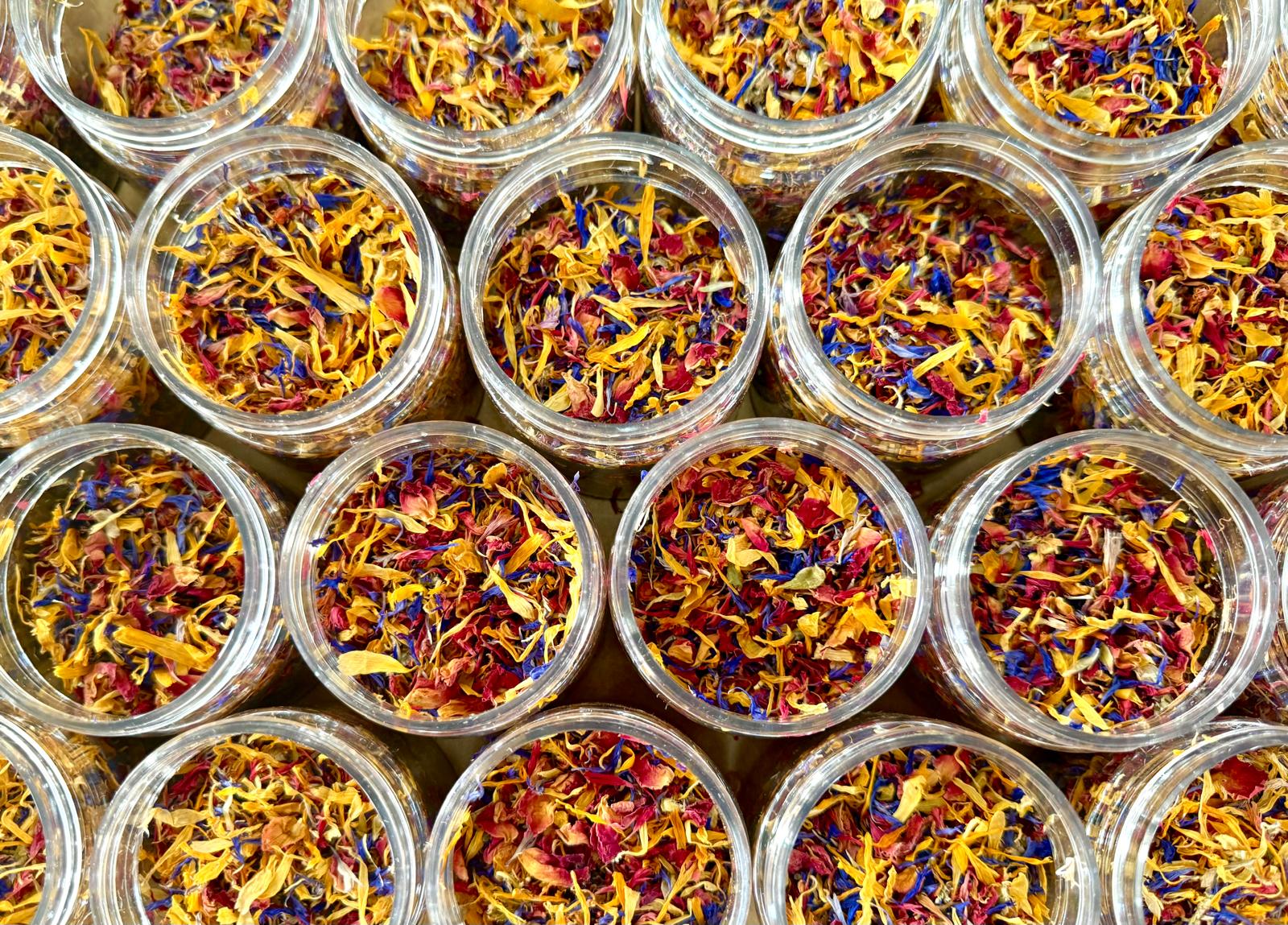 Jars filled with colorful dried flowers arranged in a grid pattern.