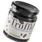 A glass jar of Truffle Pearl winter black truffle juice in premium oil, featuring a black lid and a white label with black and gold text, set against a plain white background.