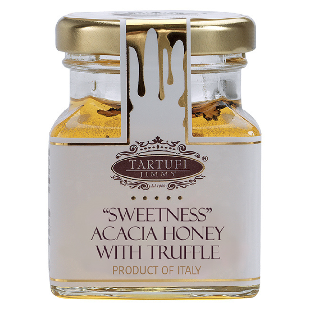 A glass jar of Tartufi Jimmy 'Sweetness' Acacia Honey with Truffle, featuring a white label with gold lettering and a gold metal lid, set against a plain white background.