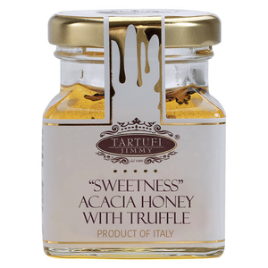 A glass jar of Tartufi Jimmy 'Sweetness' Acacia Honey with Truffle, featuring a white label with gold lettering and a gold metal lid, set against a plain white background.