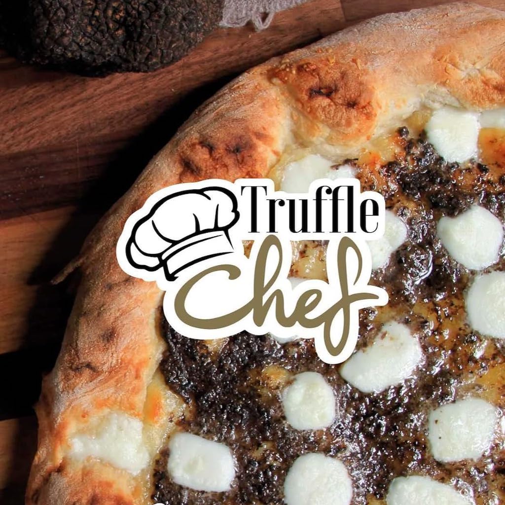 pizza on a wood table with truffle sauce of truffle chef brand, and fresh black truffle