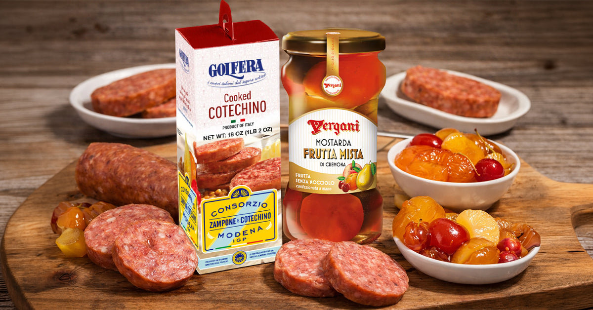Assorted Italian meats and condiments on a wooden board with a rustic background