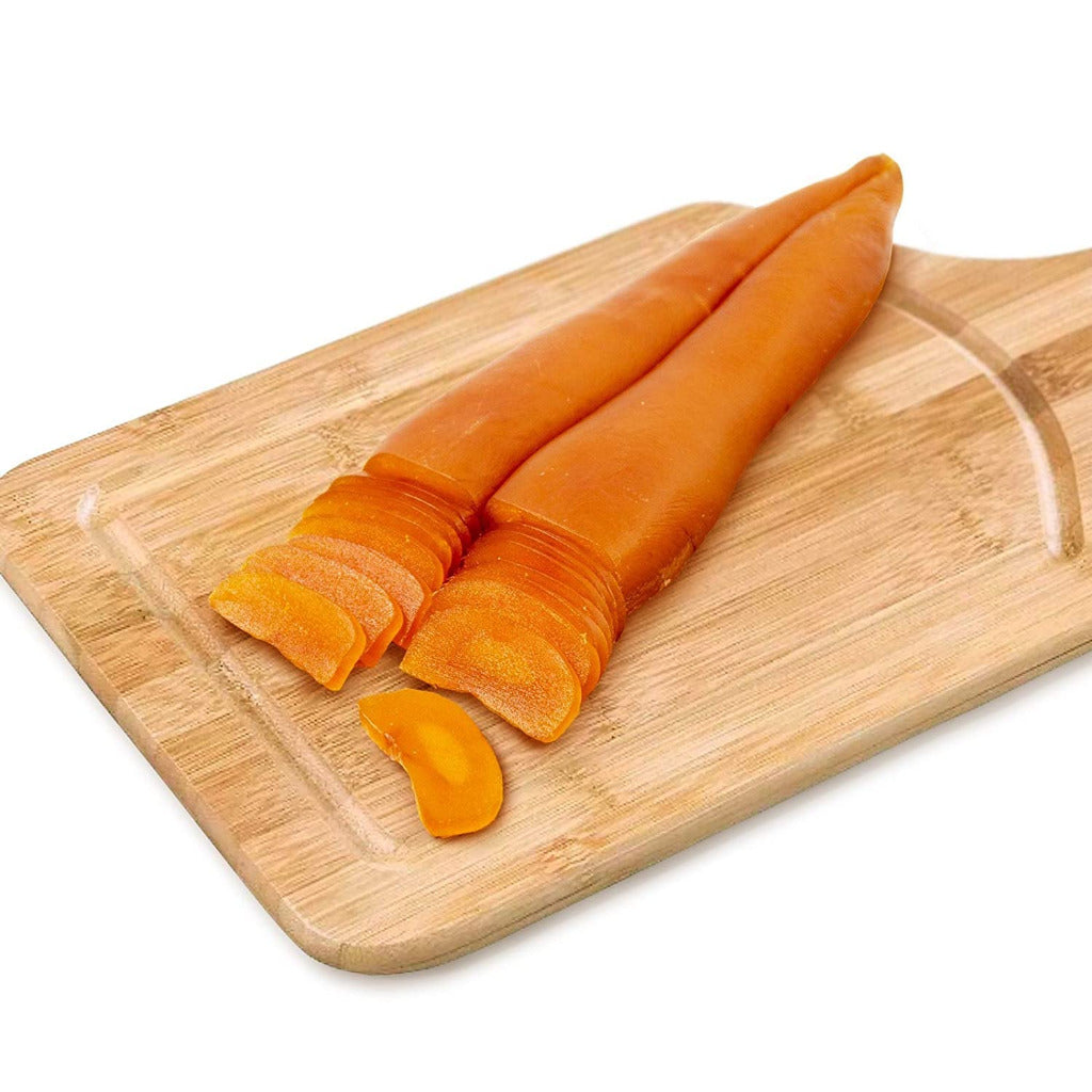 Le Meraviglie Whole Dried Mullet Roe from Sardinia sliced on a wooden cutting board